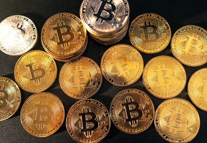 bitcoin-coins-lined-up-in-the-background-2023-11-27-05-27-55-utc.jpg