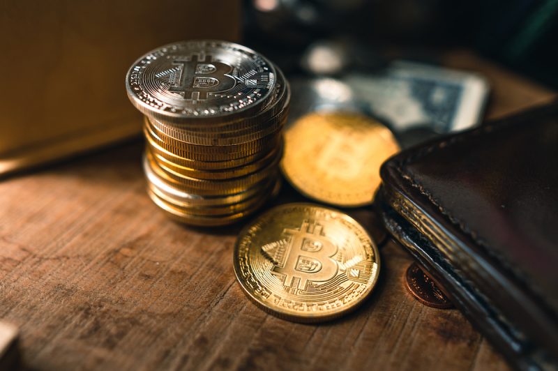 bitcoin-coins-on-a-wooden-desk-at-home-2021-10-21-04-34-32-utc.jpg