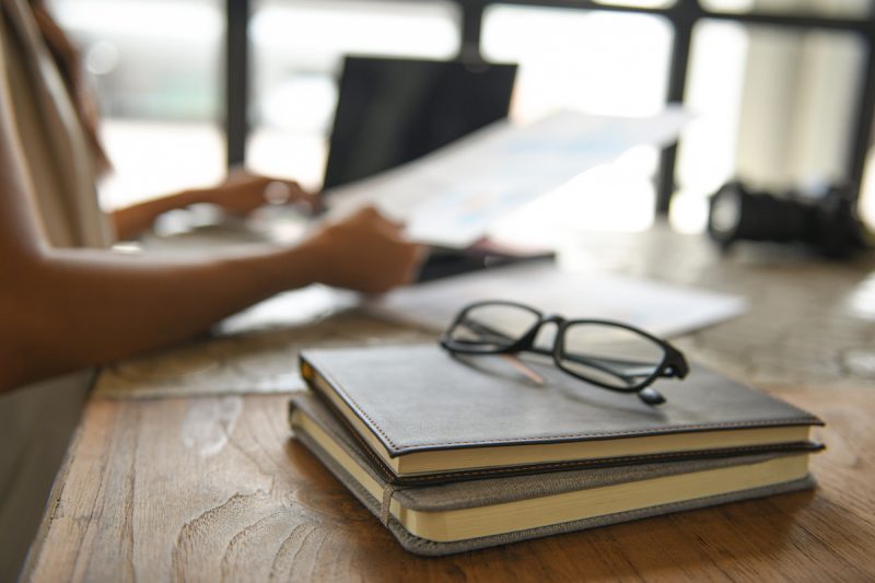 glasses-placed-on-notebooks-background-blurred-pe-2021-08-26-17-53-52-utc.jpg